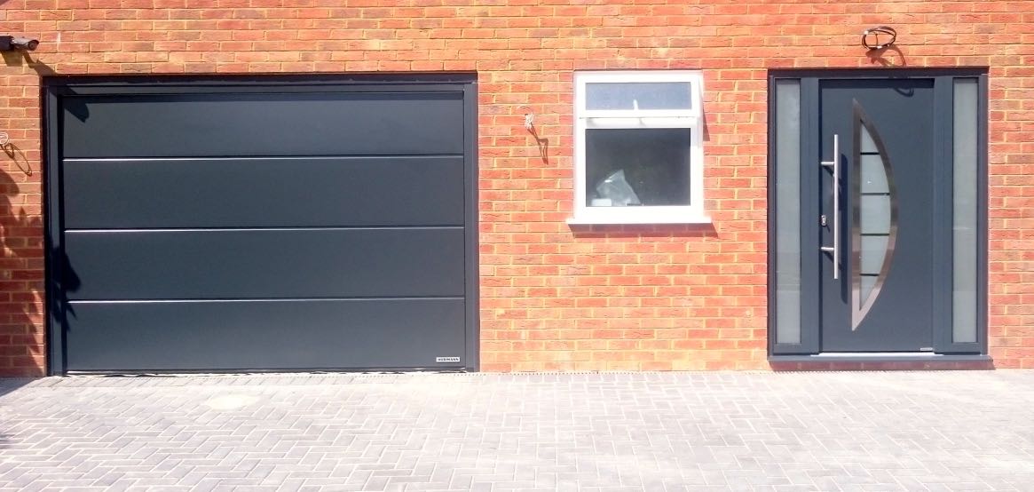 Hormann LPU42 insulated sectional and Thermo46 TPS 900 front entrance door and side elements all in Anthracite Grey